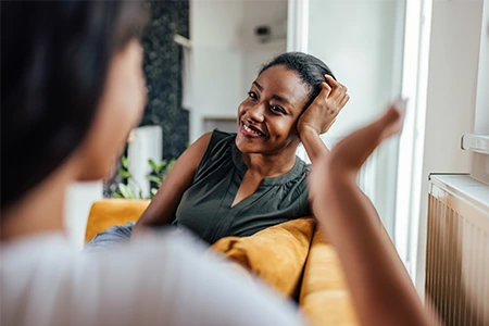 Two individuals engaged in a conversation during a psychotherapy session, symbolizing mental health counseling and support.