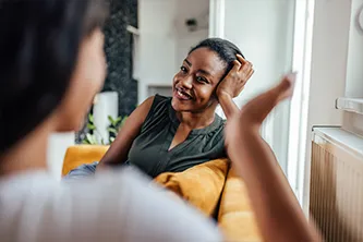Two individuals engaged in a conversation during a psychotherapy session, symbolizing mental health counseling and support.