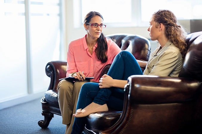 Therapist actively listening to a patient during a psychotherapy session, highlighting the supportive and confidential nature of psychotherapy.